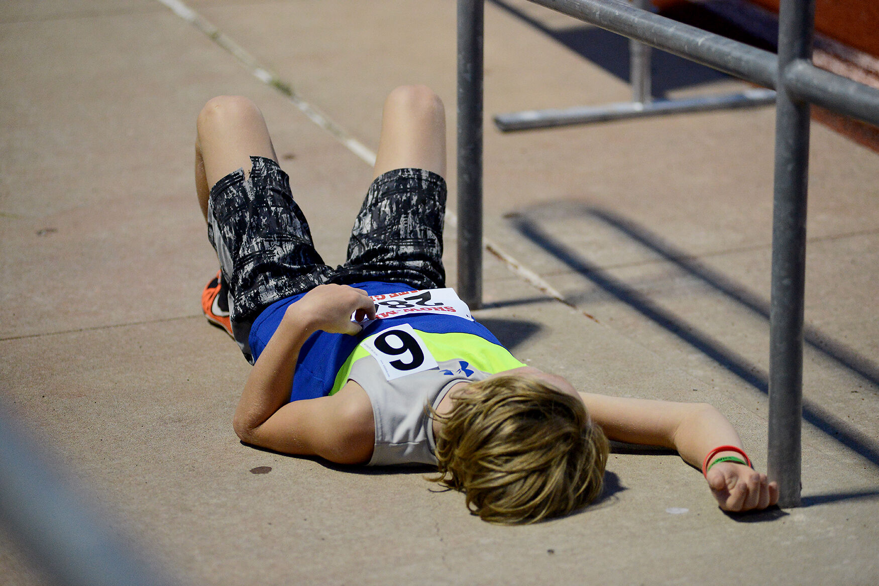 Quentin Faft lays on the ground in exhaustion after finishing his run